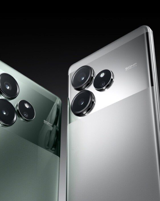 Two realme GT 6 phones, in Fluid Silver and Razor Green, angled back to back showing the triple camera module