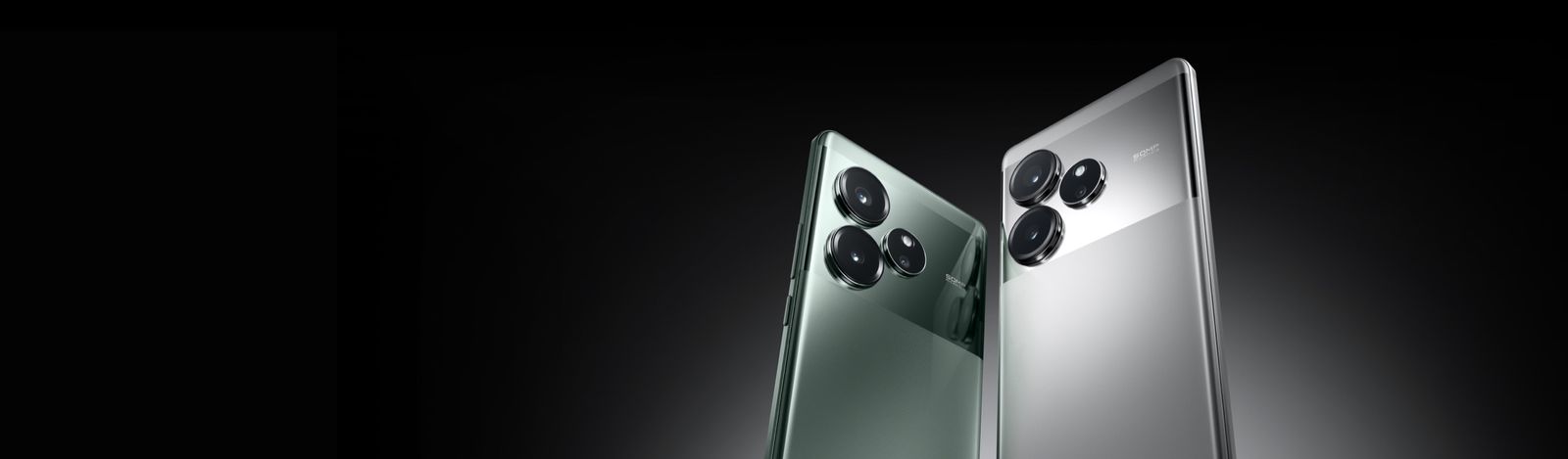 Two realme GT 6 phones, in Fluid Silver and Razor Green, angled back to back showing the triple camera module